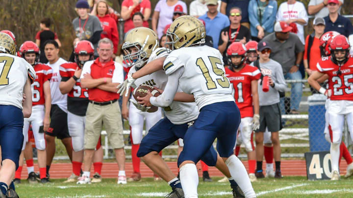 Essex's quarterback, Carter Crete hands the ball to Tanner Robbuns during the Hornets' D1 football semifinal vs the CVU Redhawks on Saturday afternoon in Hinesburg

D1 Football Semifinal Essex At Cvu 05nov22 9007