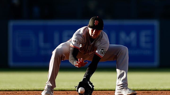 May 7, 2024; Denver, Colorado, USA; San Francisco Giants shortstop Nick Ahmed (16) fields the ball in the first inning against the Colorado Rockies at Coors Field.