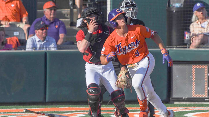 Clemson catcher Jacob Jarrell (9) hits a home run against University of Louisville during the bottom of the fifth inning at Doug Kingsmore Stadum in Clemson, S.C. Friday, April 18, 2025. The home run broke up a no-hitter and helped the Tigers win 2-1.