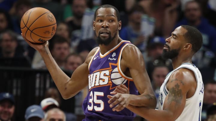 Apr 14, 2024; Minneapolis, Minnesota, USA; Phoenix Suns forward Kevin Durant (35) looks to pass as Minnesota Timberwolves guard Mike Conley (10) defends him in the fourth quarter at Target Center. Mandatory Credit: Bruce Kluckhohn-USA TODAY Sports