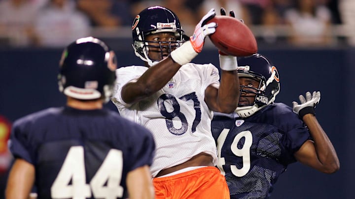 Aug 9, 2006; Chicago, IL, USA; Chicago Bears wide receiver (87) Muhsin Muhammad drops the football in the end zone while being defended by cornerback (49) Abraham Elimimian and safety (44) Cameron Worrell during training camp at Soldier Field in Chicago, IL. 