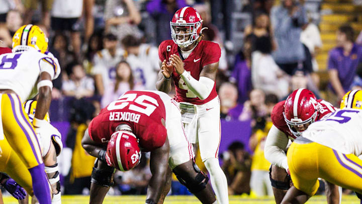 Nov 9, 2024; Baton Rouge, Louisiana, USA;  Alabama Crimson Tide quarterback Jalen Milroe (4) calls for the ball against LSU Tigers safety Major Burns (8) during the second half at Tiger Stadium. Mandatory Credit: Stephen Lew-Imagn Images