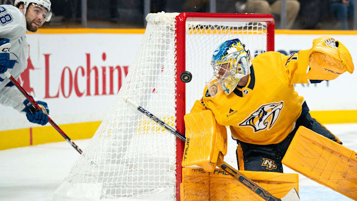 Tampa Bay left wing Brandon Hagel (38) gets off a shot against Nashville goaltender Juuse Saros (74) during their game at Bridgestone Arena in Nashville, Tenn., Tuesday, Oct. 28, 2025. Saros made the save.