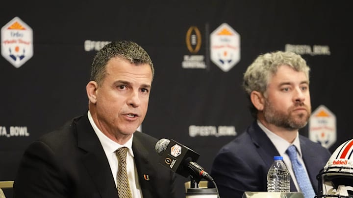 Head coach Mario Cristobal of Miami and head coach Pete Golding of Mississippi (right) make final pregame comments before their matchup at the Fiesta Bowl during a news conference at the JW Marriott Scottsdale Camelback Inn Resort on Jan. 7, 2026.