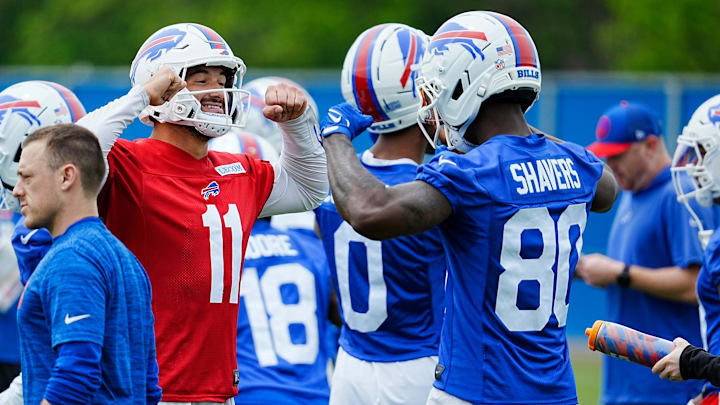 Buffalo Bills Mitchell Trubisky and Tyrell Shavers go through an elaborate handshake that also involves showing off muscles when they meet up in a smaller group where a different drill was being run at their practice facility on May 27, 2025.