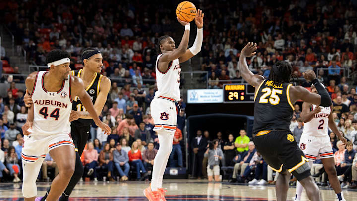 Auburn Tigers guard Miles Kelly (13) makes a three-pointer as Auburn Tigers take on Missouri Tigers at Neville Arena in Auburn, Ala., on Saturday, Jan. 4, 2025. Auburn Tigers lead Missouri Tigers 45-33 at halftime.