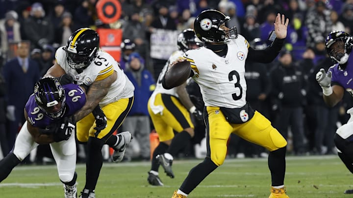 Jan 11, 2025; Baltimore, Maryland, USA; Pittsburgh Steelers quarterback Russell Wilson (3) passes the ball as Baltimore Ravens linebacker Odafe Oweh (99) chases in an AFC wild card game at M&T Bank Stadium.  