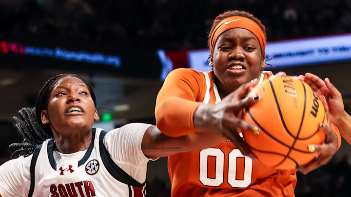 Jan 12, 2025; Columbia, South Carolina, USA; Texas Longhorns forward Kyla Oldacre (00) grabs a rebound over South Carolina Gamecocks forward Sania Feagin (20) in the second half at Colonial Life Arena. Mandatory Credit: Jeff Blake-Imagn Images