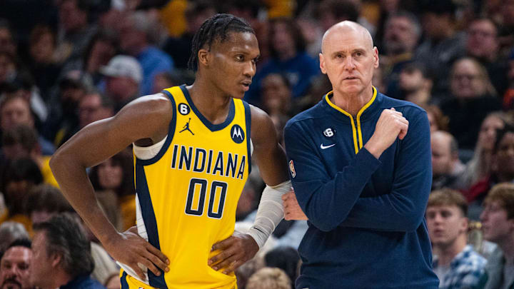 Dec 9, 2022; Indianapolis, Indiana, USA; Indiana Pacers guard Bennedict Mathurin (00) and head coach Rick Carlisle talk in the second half against the Washington Wizards at Gainbridge Fieldhouse. Mandatory Credit: Trevor Ruszkowski-Imagn Images