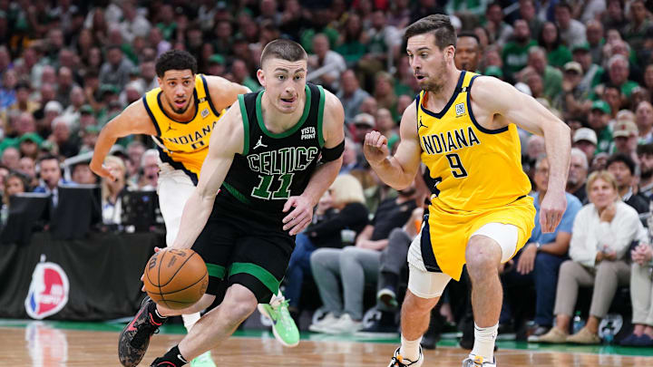 May 23, 2024; Boston Celtics guard Payton Pritchard (11) dribbles the ball past Indiana Pacers guard T.J. McConnell (9).