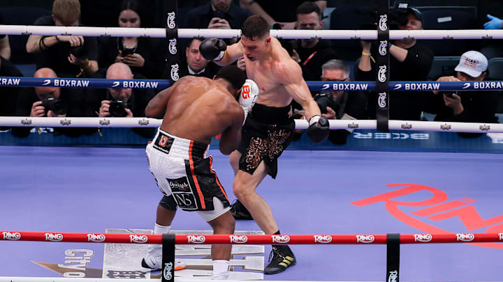 Chris Billam-Smith (right)  throwing a lead hook to the body against Brandon Glanton (left).