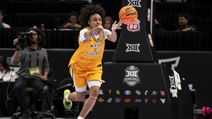 Mar 7, 2026; Kansas City, MO, USA;  West Virginia Mountaineers guard Sydney Shaw (5) passes the ball against the Colorado Buffaloes during the second half at T-Mobile Center. Mandatory Credit: Nick Tre. Smith-Imagn Images