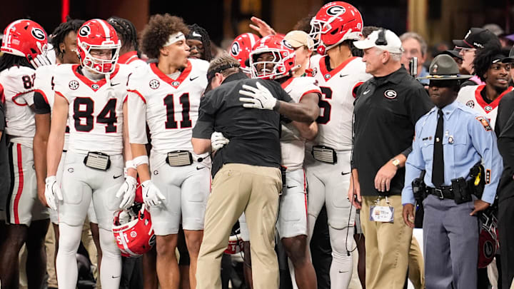 Dec 6, 2025; Atlanta, GA, USA; Georgia Bulldogs players celebrate with Georgia Bulldogs head coach Kirby Smart during the fourth quarter against the Alabama Crimson Tide  during the 2025 SEC Championship game at Mercedes-Benz Stadium. Mandatory Credit: Dale Zanine-Imagn Images