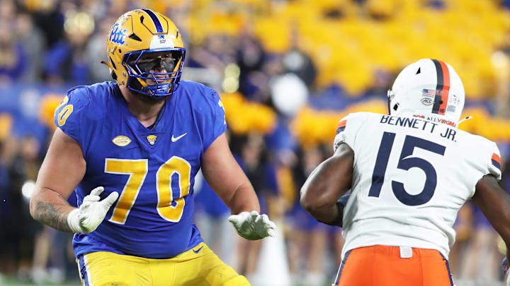 Nov 9, 2024; Pittsburgh, Pennsylvania, USA;  Pittsburgh Panthers offensive lineman Ryan Baer (70) blocks at the line of scrimmage against Virginia Cavaliers defensive end Chico Bennett Jr. (15) during the second quarter at Acrisure Stadium. Mandatory Credit: Charles LeClaire-Imagn Images