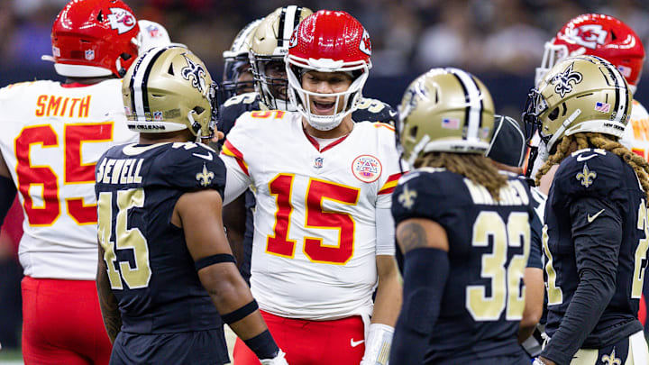 Aug 13, 2023; New Orleans, Louisiana, USA; Kansas City Chiefs quarterback Patrick Mahomes (15) talks to New Orleans Saints linebacker Nephi Sewell (45) and safety Tyrann Mathieu (32) after being tackled during the first half at the Caesars Superdome. Mandatory Credit: Stephen Lew-Imagn Images