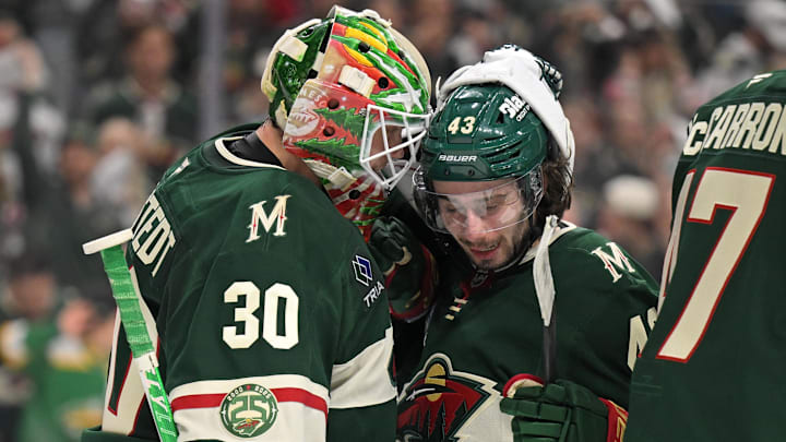 Minnesota Wild goalie Jesper Wallstedt (30) and defensemen Quinn Hughes (43) celebrate a series win against the Dallas Stars after game six of the first round of the 2026 Stanley Cup Playoffs at Grand Casino Arena. Mandatory Credit: Nick Wosika-Imagn Images