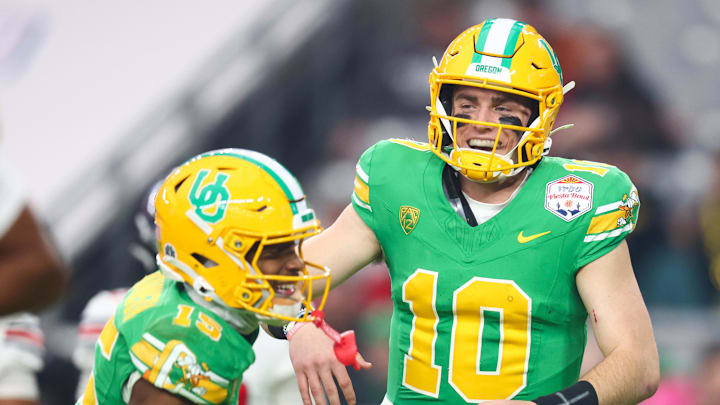 Jan 1, 2024; Glendale, AZ, USA; Oregon Ducks quarterback Bo Nix (10) celebrates a touchdown with wide receiver Tez Johnson (15) during the second half against the Liberty Flames in the 2024 Fiesta Bowl at State Farm Stadium. Mandatory Credit: Mark J. Rebilas-Imagn Images Jan 1, 2024; Glendale, AZ, USA; Oregon Ducks quarterback Bo Nix (10) celebrates a touchdown with wide receiver Tez Johnson (15) during the second half against the Liberty Flames in the 2024 Fiesta Bowl at State Farm Stadium. Mandatory Credit: Mark J. Rebilas-Imagn Images