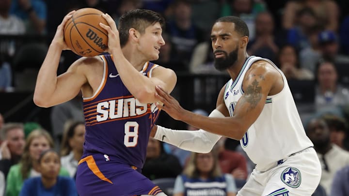 Apr 14, 2024; Minneapolis, Minnesota, USA; Phoenix Suns guard Grayson Allen (8) works around Minnesota Timberwolves guard Mike Conley (10) in the fourth quarter at Target Center. Mandatory Credit: Bruce Kluckhohn-Imagn Images