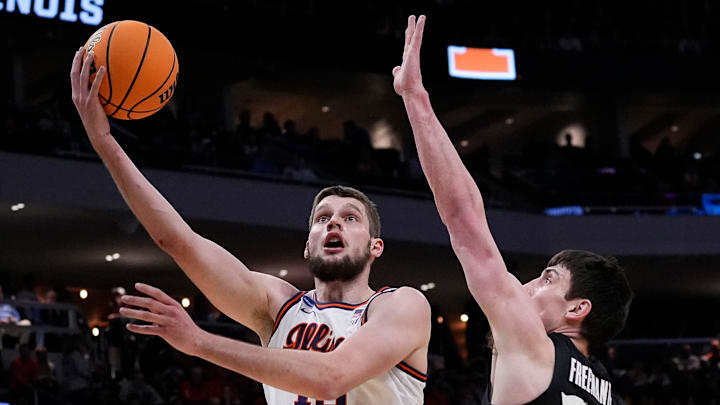 Illinois center Tomislav Ivisic (13) attempts to score as Xavier forward Zach Freemantle goes for a block during the first half of their first round NCAA men’ s basketball tournament game on Friday March 21, 2025 at Fiserv Forum in Milwaukee, Wis.