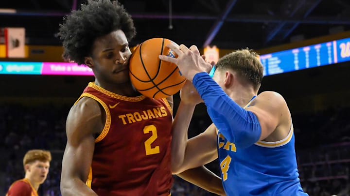 Feb 24, 2026; Los Angeles, California, USA; UCLA Bruins forward Tyler Bilodeau (34) collides with Southern California Trojans forward Ezra Ausar (2) as he drives the baseline during the second half at Pauley Pavilion presented by Wescom Financial. Mandatory Credit: Robert Hanashiro-Imagn Images