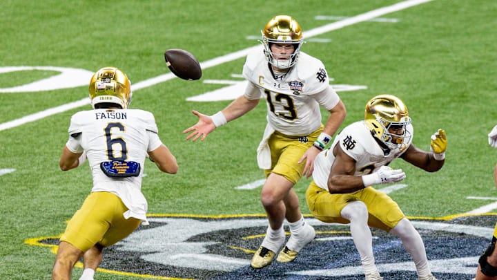 Jan 2, 2025; New Orleans, LA, USA; Notre Dame Fighting Irish quarterback Riley Leonard (13) flips the ball to Notre Dame Fighting Irish wide receiver Jordan Faison (6) on a play against the Georgia Bulldogs during the second half at Caesars Superdome. Jan 2, 2025; New Orleans, LA, USA; Notre Dame Fighting Irish quarterback Riley Leonard (13) flips the ball to Notre Dame Fighting Irish wide receiver Jordan Faison (6) on a play against the Georgia Bulldogs during the second half at Caesars Superdome.