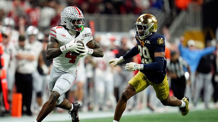 Ohio State Buckeyes wide receiver Jeremiah Smith (4) makes a catch against Notre Dame Fighting Irish cornerback Christian Gray (29) in the fourth quarter during the College Football Playoff National Championship at Mercedes-Benz Stadium in Atlanta on January 20, 2025.
