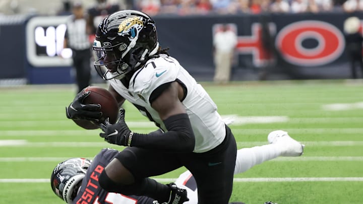 Sep 29, 2024; Houston, Texas, USA; Jacksonville Jaguars wide receiver Brian Thomas Jr. (7) is tackled by Houston Texans cornerback Kamari Lassiter (4) in the second half at NRG Stadium. Mandatory Credit: Thomas Shea-Imagn Images Sep 29, 2024; Houston, Texas, USA; Jacksonville Jaguars wide receiver Brian Thomas Jr. (7) is tackled by Houston Texans cornerback Kamari Lassiter (4) in the second half at NRG Stadium. Mandatory Credit: Thomas Shea-Imagn Images