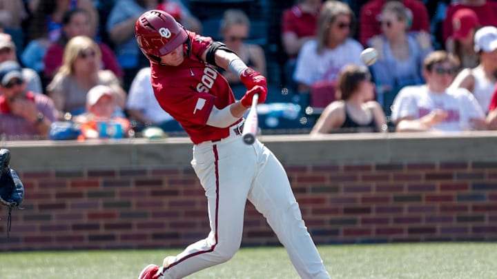 Oklahoma catcher Easton Carmichael (2) hits during the Bedlam baseball game between the Oklahoma Sooners and the Oklahoma State Cowboys at L. Dale Mitchell Park in Norman, Okla., on Saturday, May 20, 2023.