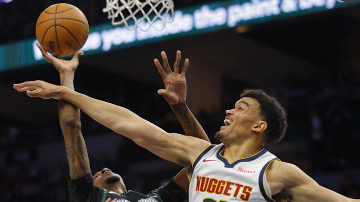 Apr 23, 2026; Minneapolis, Minnesota, USA; Minnesota Timberwolves forward Jaden McDaniels (3) shoots against Denver Nuggets forward Spencer Jones (21) in the first quarter at Target Center. Mandatory Credit: Bruce Kluckhohn-Imagn Images
