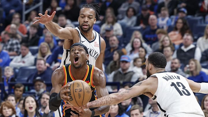 Jan 19, 2025; Oklahoma City, Oklahoma, USA; Oklahoma City Thunder guard Shai Gilgeous-Alexander (2) drives to the basket between Brooklyn Nets forward Tosan Evbuomwan (12) and guard Tyrese Martin (13) during the second half at Paycom Center. Mandatory Credit: Alonzo Adams-Imagn Images