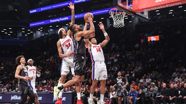 Jan 8, 2025; Brooklyn, New York, USA;  Brooklyn Nets forward Tosan Evbuomwan (12) looks to drive past Detroit Pistons forward Bobi Klintman (34): Wendell Cruz-Imagn Images