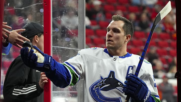 Jan 15, 2023; Raleigh, North Carolina, USA; Vancouver Canucks center Bo Horvat (53) hands a fan a Jan 15, 2023; Raleigh, North Carolina, USA; Vancouver Canucks center Bo Horvat (53) hands a fan a