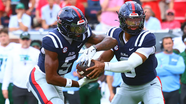 Sep 20, 2025; Oxford, Mississippi, USA; Mississippi Rebels quarterback Trinidad Chambliss (6) hands the ball off to running back Kewan Lacy (5) during the first quarter against the Tulane Green Wave at Vaught-Hemingway Stadium. Mandatory Credit: Petre Thomas-Imagn Images