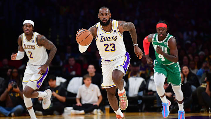 Dec 25, 2023; Los Angeles, California, USA; Los Angeles Lakers forward LeBron James (23) moves the ball up court ahead of forward Jarred Vanderbilt (2) and Boston Celtics guard Jrue Holiday (4) during the first half at Crypto.com Arena. Mandatory Credit: Gary A. Vasquez-Imagn Images