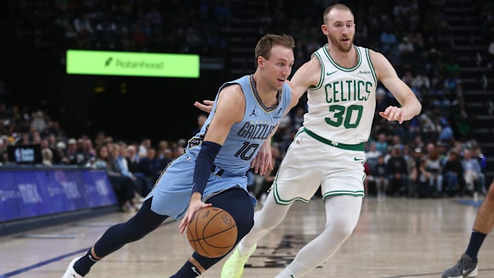 Mar 31, 2025; Memphis, Tennessee, USA; Memphis Grizzlies guard Luke Kennard (10) drives to the basket as Boston Celtics forward Sam Hauser (30) defends during the third quarter at FedExForum. Mandatory Credit: Petre Thomas-Imagn Images
