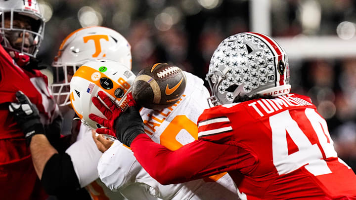 Ohio State Buckeyes defensive end JT Tuimoloau (44) attempts to grab the ball against Tennessee Volunteers quarterback Nico Iamaleava in their first-round playoff game. OSU won 42-17 as Iamaleava completed 14-31 passes for 104 yards.