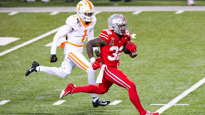 Ohio State Buckeyes running back TreVeyon Henderson (32) runs the ball against Tennessee Volunteers defensive back Rickey Gibson III (1) in the second half at Ohio Stadium on Saturday, Dec. 21, 2024 in Columbus, Ohio.
