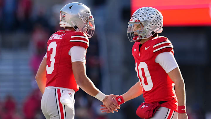 Ohio State Buckeyes quarterback Julian Sayin (10) subs in for quarterback Lincoln Kienholz (3) during the NCAA football game against the Rutgers Scarlet Knights at Ohio Stadium in Columbus on Nov. 22, 2025. Ohio State won 42-9.
