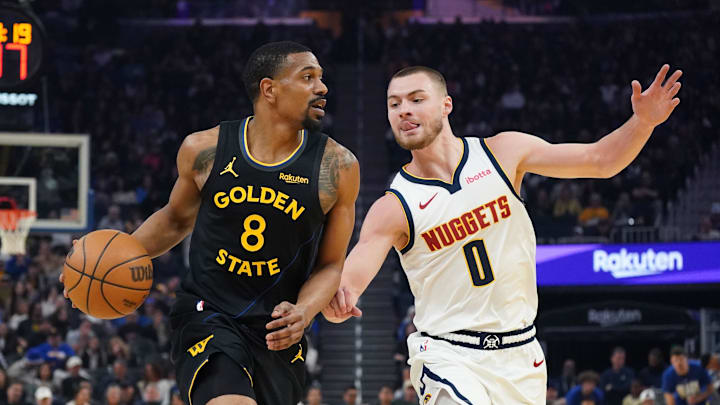 Feb 22, 2026; San Francisco, California, USA;  Golden State Warriors guard De'Anthony Melton (8) dribbles against Denver Nuggets guard Christian Braun (0) in the first quarter at Chase Center. Mandatory Credit: David Gonzales-Imagn Images