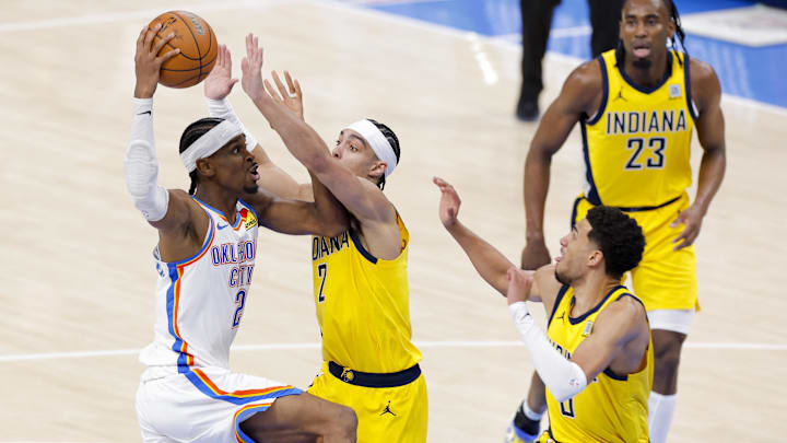 Jun 5, 2025; Oklahoma City, Oklahoma, USA; Oklahoma City Thunder guard Shai Gilgeous-Alexander (2) looks to pass the ball by Indiana Pacers guard Andrew Nembhard (2) and Indiana Pacers guard Tyrese Haliburton (0) during the fourth quarter during game one of the 2025 NBA Finals at Paycom Center. Mandatory Credit: Alonzo Adams-Imagn Images