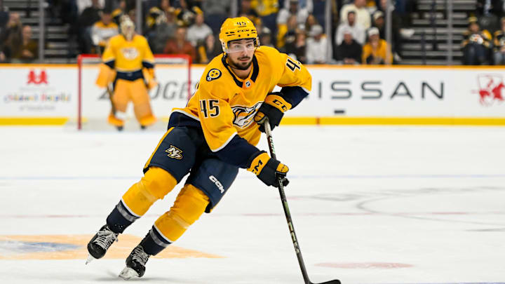 Oct 22, 2024; Nashville, Tennessee, USA;  Nashville Predators defenseman Alexandre Carrier (45) skates with the puck against the Boston Bruins uring the third period at Bridgestone Arena. Mandatory Credit: Steve Roberts-Imagn Images