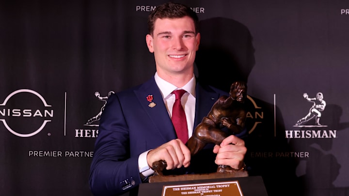 Dec 13, 2025; New York, NY, USA; Indiana Hoosiers quarterback Fernando Mendoza poses for photos with the Heisman trophy during a press conference at the New York Marriott Marquis after winning the award. 