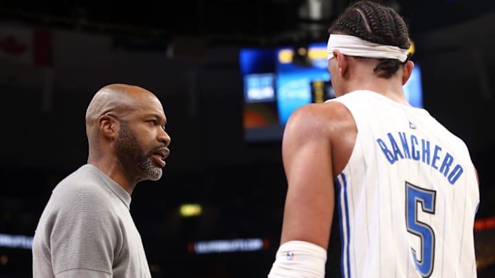 Mar 28, 2023; Memphis, Tennessee, USA; Orlando Magic head coach Jamahl Mosley (left) talks with forward Paolo Banchero (5) during a timeout during the second half against the Memphis Grizzlies at FedExForum. Mandatory Credit: Petre Thomas-Imagn Images