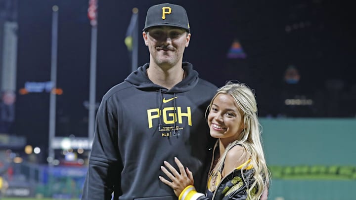 May 11, 2024; Pittsburgh, Pennsylvania, USA;  Pittsburgh Pirates starting pitcher Paul Skenes (30) poses with his girlfriend Louisiana State University gymnast Olivia Dunn (right) after making his major league debut against the Chicago Cubs at PNC Park. The Pirates won 10-8. Mandatory Credit: Charles LeClaire-Imagn Images