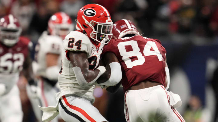 Dec 2, 2023; Atlanta, GA, USA; Alabama Crimson Tide tight end Amari Niblack (84) makes a catch against Georgia Bulldogs defensive back Malaki Starks (24) during the first half in the SEC Championship game at Mercedes-Benz Stadium. Mandatory Credit: Dale Zanine-USA TODAY Sports