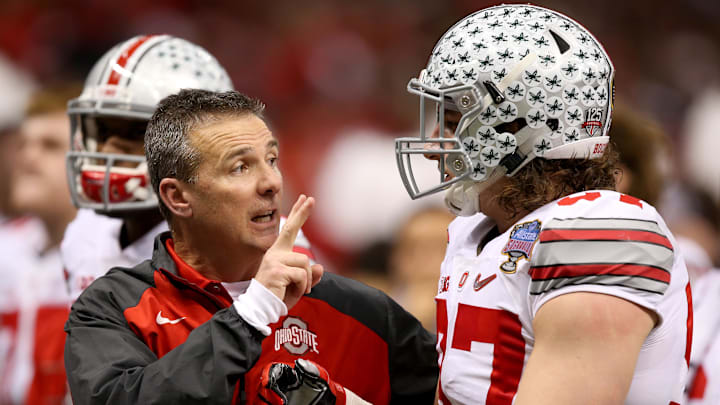 Jan 1, 2015; New Orleans, LA, USA; Ohio State Buckeyes head coach Urban Meyer talks with Ohio State Buckeyes defensive lineman Joey Bosa (97) before in the third quarter of the 2015 Sugar Bowl at Mercedes-Benz Superdome. Mandatory Credit: Chuck Cook-Imagn Images