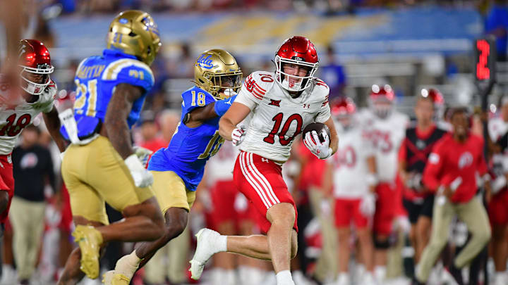 Aug 30, 2025; Pasadena, California, USA; Utah Utes tight end Hunter Andrews (10) runs the ball against UCLA Bruins defensive back Jadyn Marshall (18) during the second half at Rose Bowl. Mandatory Credit: Gary A. Vasquez-Imagn Images
