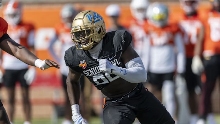 Jan 29, 2025; Mobile, AL, USA; National team defensive lineman Oluwafemi Oladejo of UCLA (99) runs through a drill during Senior Bowl practice at Hancock Whitney Stadium. Mandatory Credit: Vasha Hunt-Imagn Images