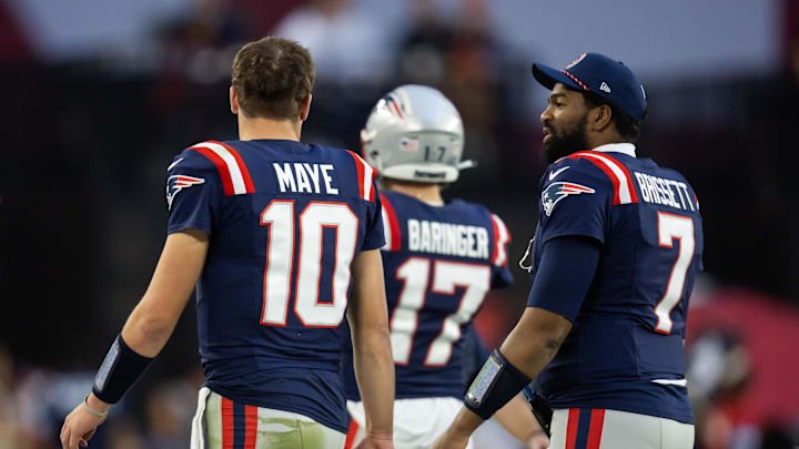 Dec 15, 2024; Glendale, Arizona, USA; New England Patriots quarterback Drake Maye (10) and Jacoby Brissett (7) against the Arizona Cardinals at State Farm Stadium. Mandatory Credit: Mark J. Rebilas-Imagn Images