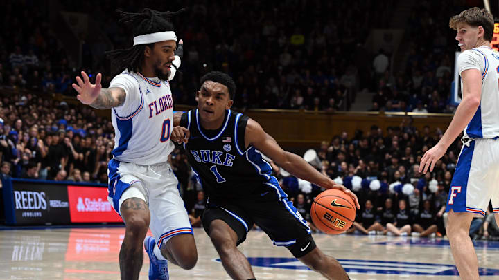 Dec 2, 2025; Durham, North Carolina, USA; Duke basketball guard Caleb Foster (1) drives to the basket as Florida Gators guard Boogie Fland (0) defends during the second half at Cameron Indoor Stadium. The Blue Devils won 67-66. Dec 2, 2025; Durham, North Carolina, USA; Duke basketball guard Caleb Foster (1) drives to the basket as Florida Gators guard Boogie Fland (0) defends during the second half at Cameron Indoor Stadium. The Blue Devils won 67-66.